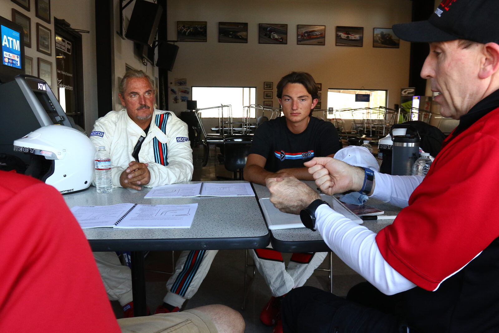 A FastLane instructor briefing a student in our Buttonwillow garage