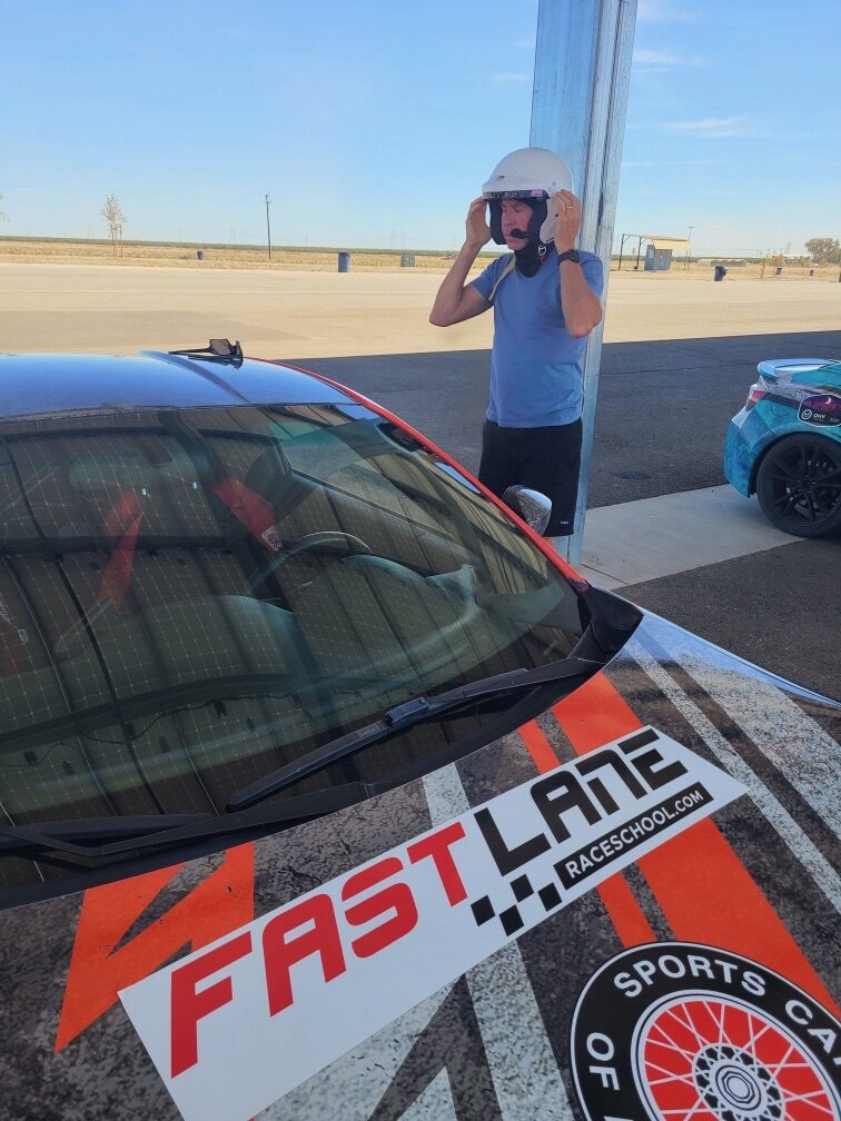 A FastLane Racing School branded car in the Buttonwillow paddock
