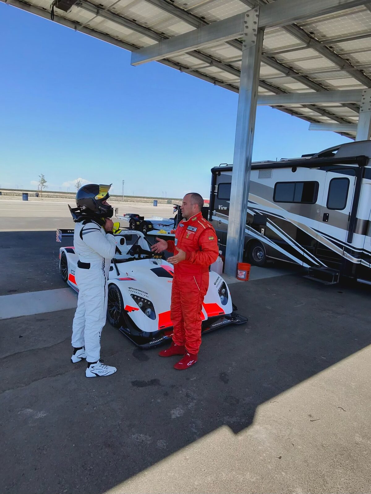 A FastLane driver and instructor in the Buttonwillow paddock
