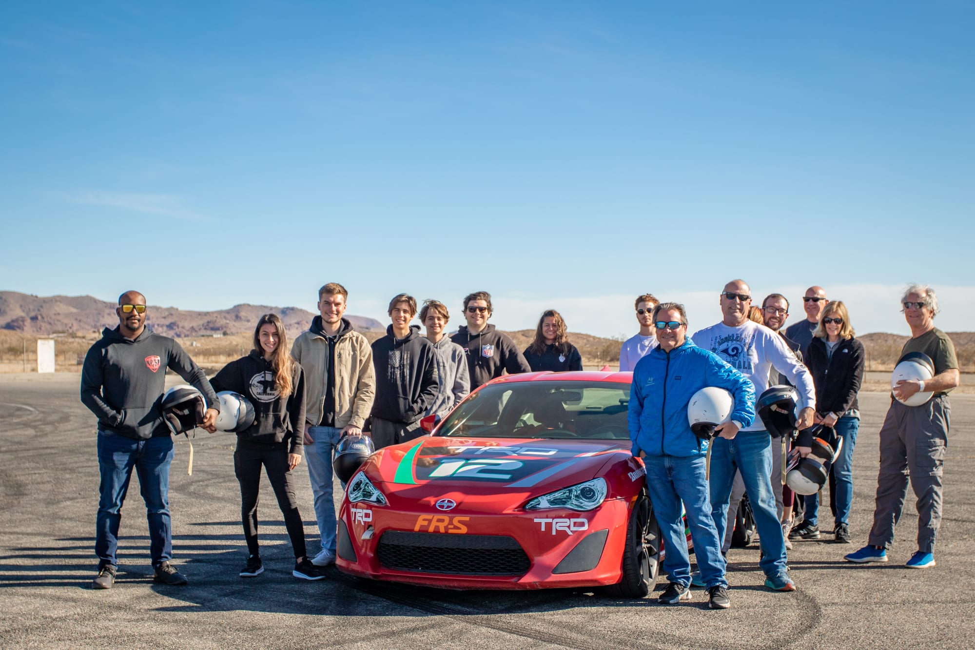 A group of participants together at a FastLane corporate and team track event at Buttonwillow.