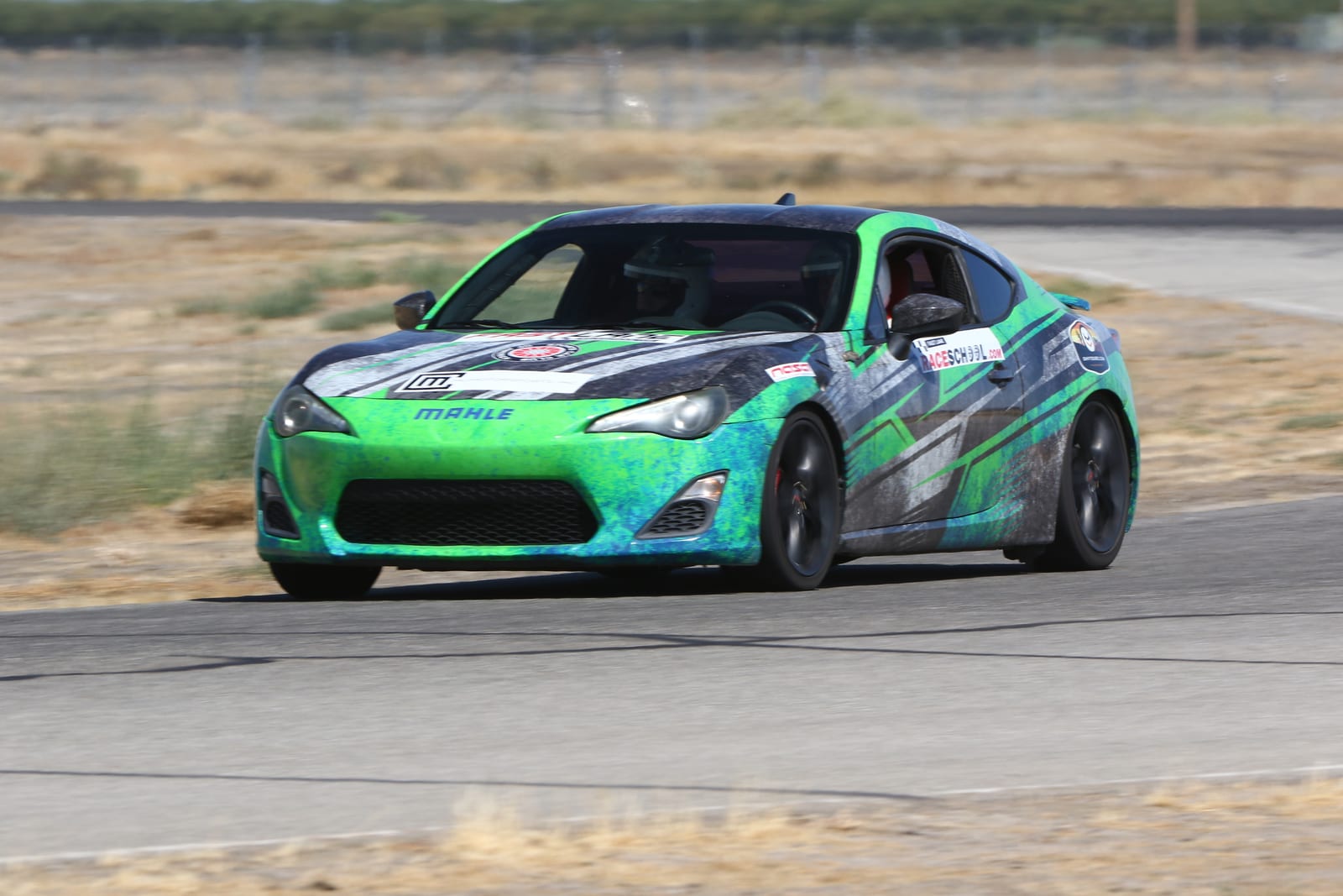 A race-prepped car on track at Buttonwillow Raceway Park.