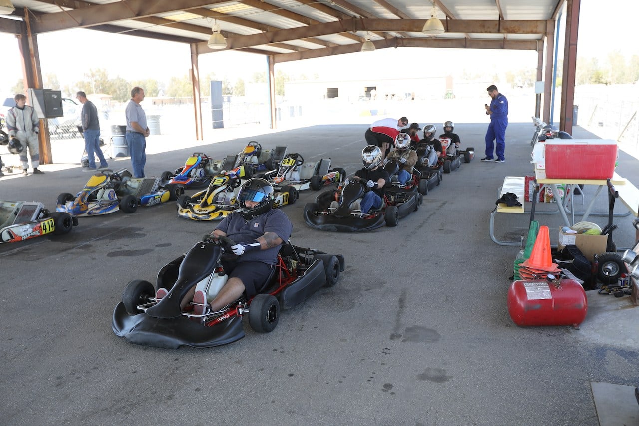 Drivers staged in their competition karts under the SoCal Karts paddock pavilion before a session.